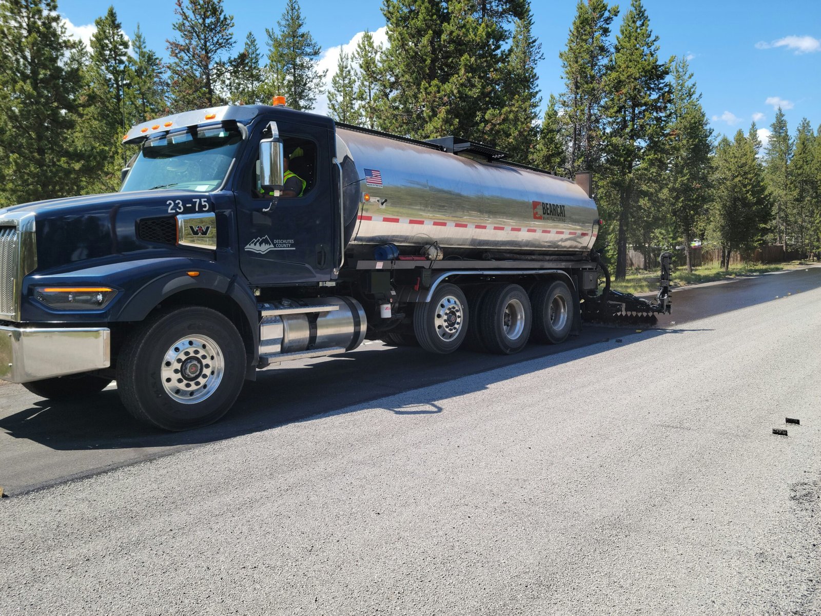 a large tanker truck is parked on the side of the road