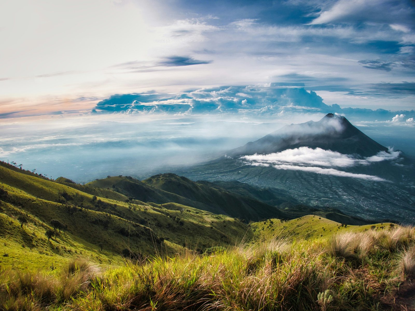 a view of a mountain range with clouds in the sky